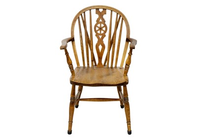 Lot 1199 - An ash and elm Windsor wheel back armchair.