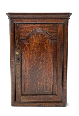 Lot 1061 - A George III small oak corner cupboard.