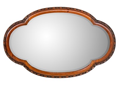 Lot 68 - A late Victorian walnut quatrefoil mirror.