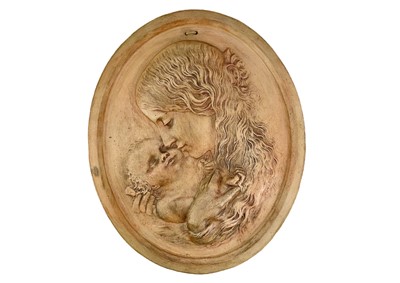 Lot 282 - A terracotta wall plaque of oval form, decorated in relief with the portrait of a mother and child.