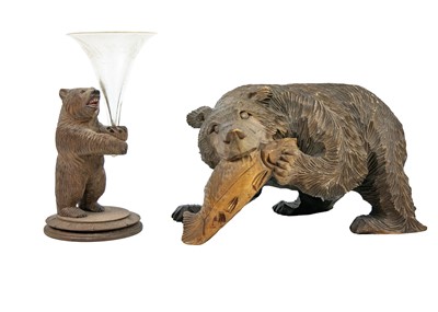 Lot 220 - A Black Forest type carved wood sculpture of a bear with a salmon.