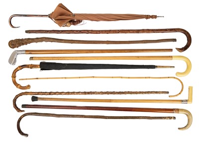 Lot 143 - A collection of eleven walking canes and umbrellas.