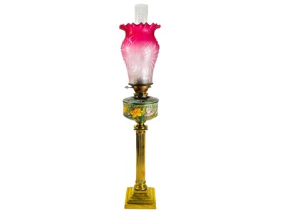Lot 94 - A Victorian cranberry shade brass oil lamp.