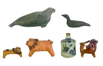 Lot 302 - Two Canadian Inuit hardstone carvings comprising a recumbent seal and a bird.