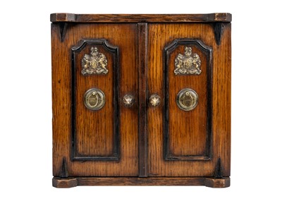 Lot 274 - A late Victorian oak smokers cabinet.