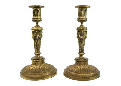 Lot 230 - A pair of 19th century gilt metal neo classical candleholders.