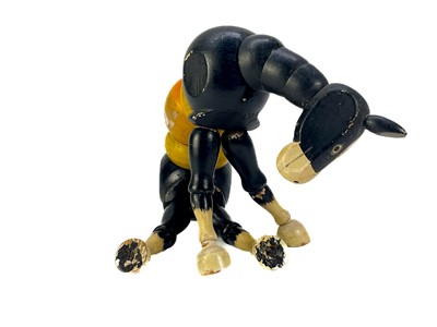 Lot 157 - A carved wood automaton in the form of a seated whipped with 'beating' heart.