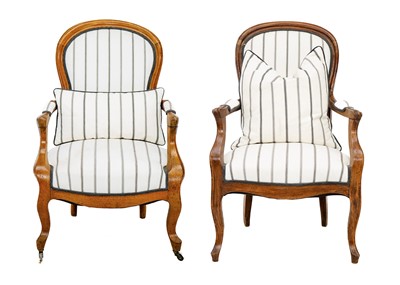 Lot 582 - Two matched French walnut upholstered fauteuil armchairs.