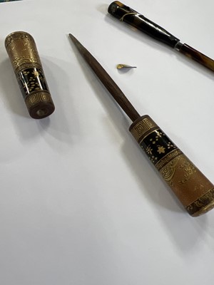 Lot 495 - Twenty Japanese black and mainly gilt laquer kogai, 19th/20th century.