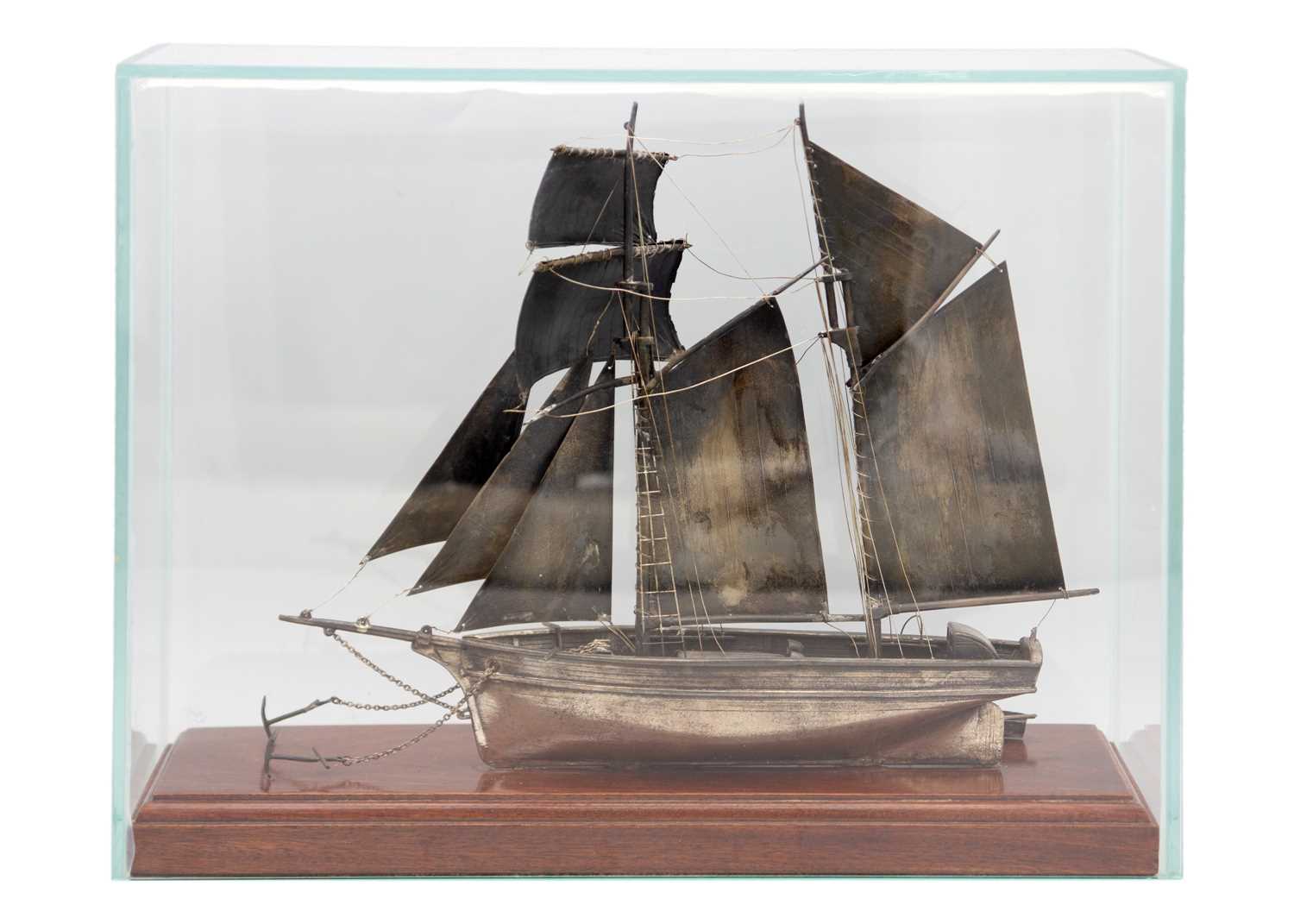 Lot 130 - A good modern hallmarked silver model of a Topsail Schooner in a glass display case.