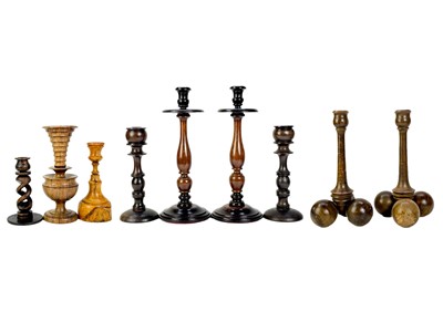 Lot 337 - A collection of nine treen candlesticks.