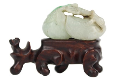 Lot 526 - A Chinese carved jade goose turned to grasp lotus, Qing Dynasty, 19th century.