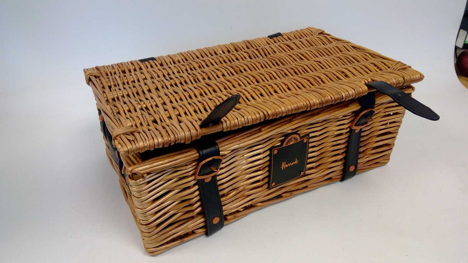 Lot 70 A small 'Harrods' wicker picnic basket with