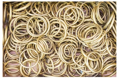 Lot 99 - A large quantity of hollow brass curtain rings.