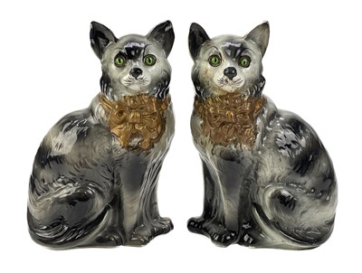 Lot 443 - A pair of Staffordshire pottery fireside cats.