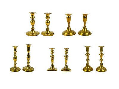 Lot 121 - A pair of 19th century brass candlesticks.