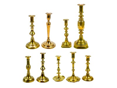 Lot 162 - An 18th century brass candlestick with petal base.