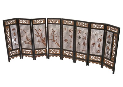 Lot 577 - A Chinese carved wood eight paneled screen, early 20th century.