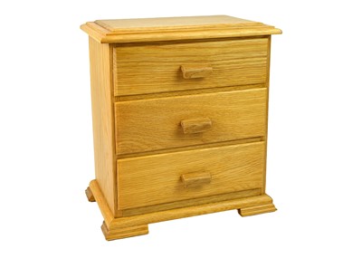 Lot 22 - An oak jewellery box in the form of a chest of drawers