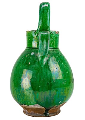 Lot 1100 - A French green glazed walnut oil jar.