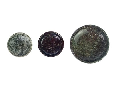 Lot 73 - A Cornish serpentine door stop with brass loop handle.