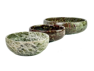 Lot 73 - A Cornish serpentine door stop with brass loop handle.