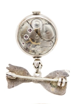 Lot 225 - A Tudor silver nurses 'ball' watch on a silver ribbon brooch and a 935 silver enamel fob watch.