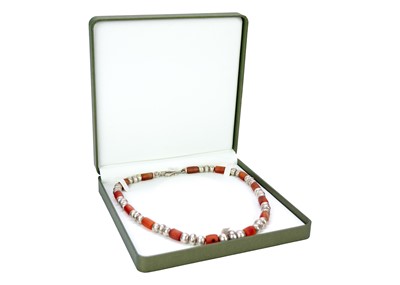 Lot 253 - A Christine Povey necklace with orange beads...