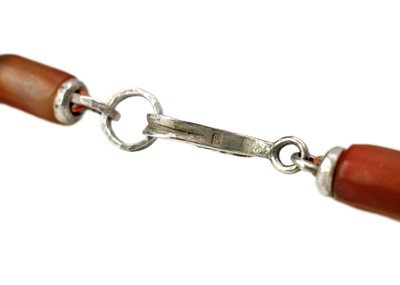 Lot 253 - A Christine Povey necklace with orange beads...