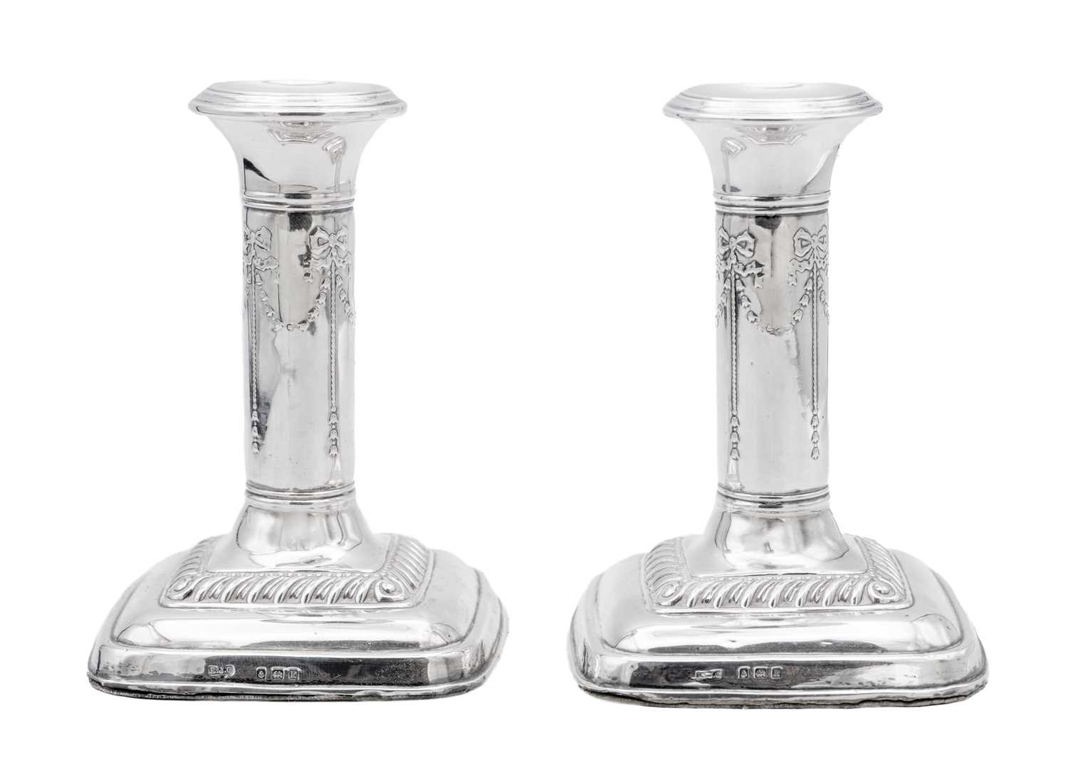 Lot 38 - An Edwardian pair of silver weighted candlesticks by Mark Ellis & Co.