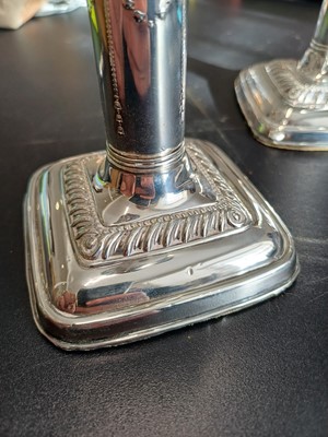 Lot 38 - An Edwardian pair of silver weighted candlesticks by Mark Ellis & Co.