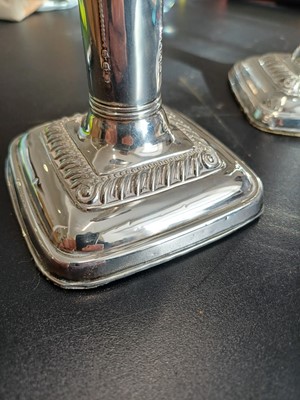 Lot 38 - An Edwardian pair of silver weighted candlesticks by Mark Ellis & Co.