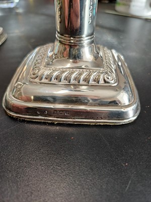 Lot 38 - An Edwardian pair of silver weighted candlesticks by Mark Ellis & Co.
