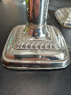 Lot 38 - An Edwardian pair of silver weighted candlesticks by Mark Ellis & Co.