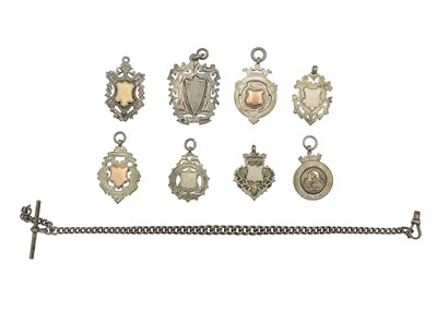 Lot 79 - A selection of eight silver shield watch fobs and a silver Albert watch chain.