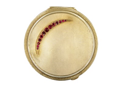 Lot 144 - A modern silver gilt compact applied with a 9ct garnet and diamond crescent.