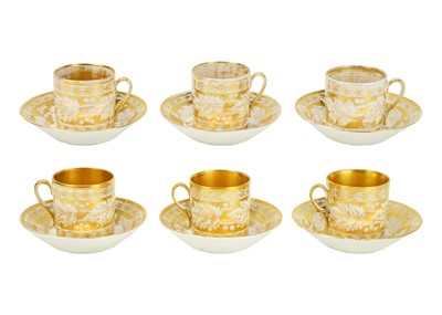 Lot 388 - A set of six gilt decorated coffee cans and saucers.