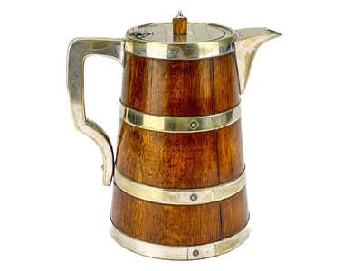 Lot 51 - An Edwardian oak coopered ale jug.