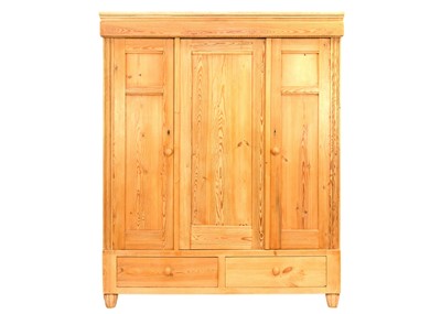 Lot 1711 - A pine triple fronted wardrobe.