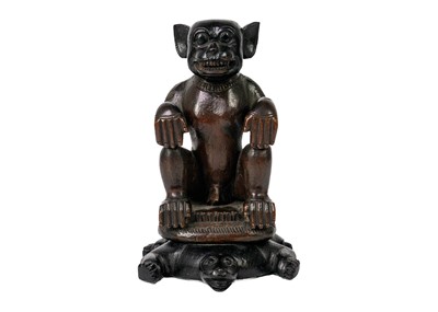 Lot 196 - A hardwood monkey sat on a tortoise.