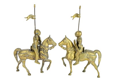 Lot 155 - A pair of brass knights on horseback.