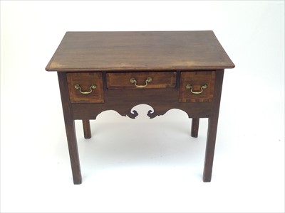 Lot 3495 - A George III oak lowboy, with crossbanded top...