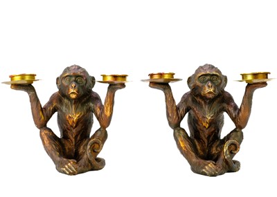 Lot 110 - A pair of resin tealight holders modelled as seated monkeys.