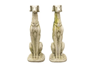 Lot 548 - A pair of large reconstituted stone seated whippet garden ornaments.