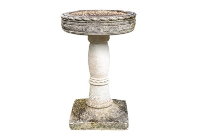 Lot 538 - A reconstituted stone bird bath of circular form, on square base.