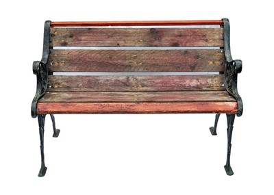 Lot 549 - A cast metal and slatted wood two seat garden bench.