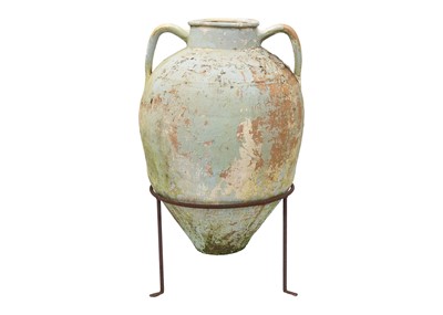 Lot 553 - A twin handled terracotta olive jar, with traces of cream and green paint.