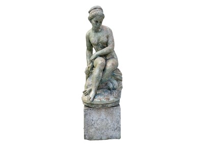 Lot 543 - A green painted garden statue of a seated female nude.