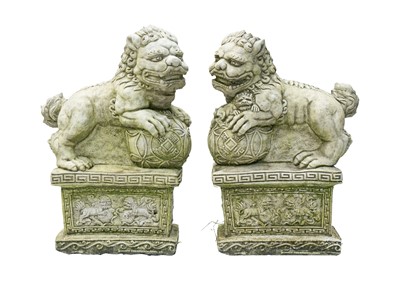 Lot 544 - A pair of reconstituted stone Chinese lion dog garden ornaments.