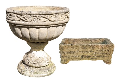 Lot 534 - A composition stone urn shape garden planter with fruiting vine decoration.